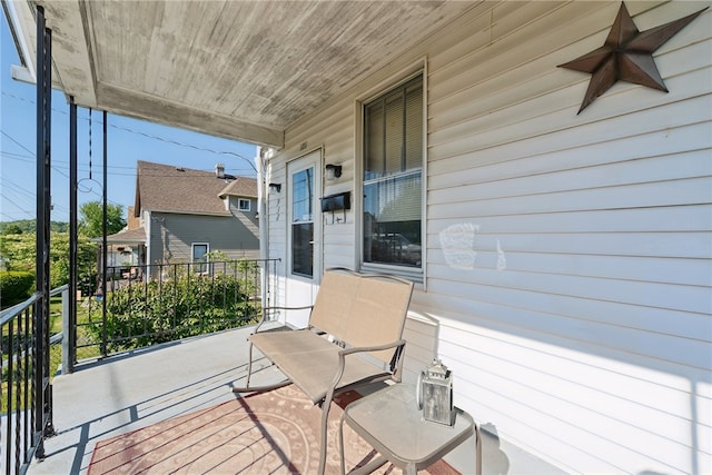 balcony with ceiling fan and a porch