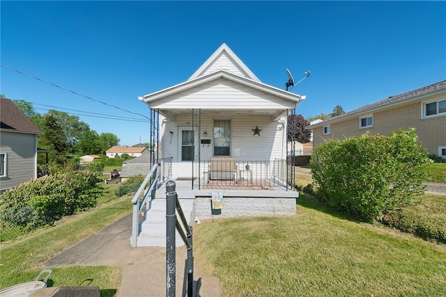 view of front of house with a porch and a front lawn