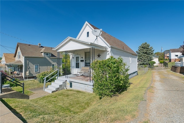 bungalow-style home with a front lawn and a porch