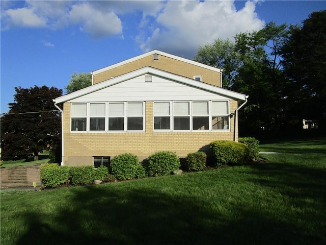 view of side of home featuring a lawn