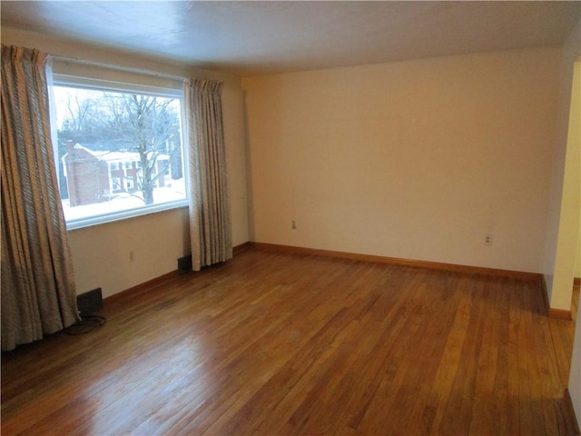 spare room with hardwood / wood-style floors