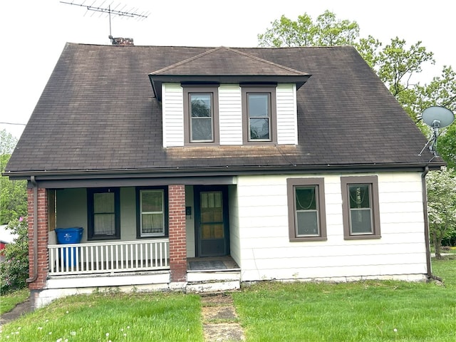 view of front of home with a front yard and covered porch