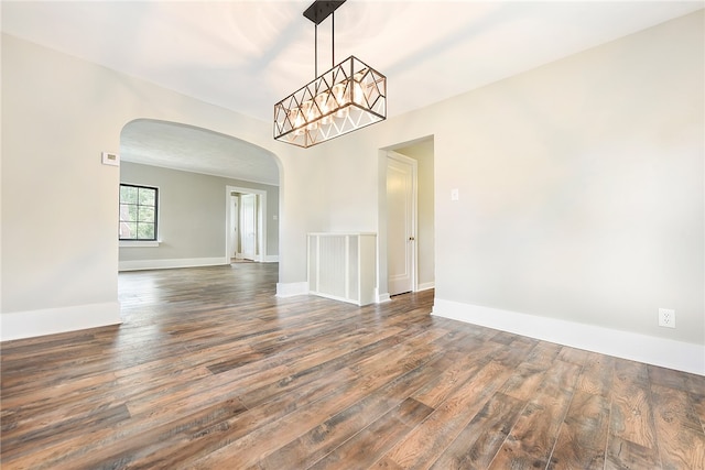 spare room featuring dark wood-type flooring