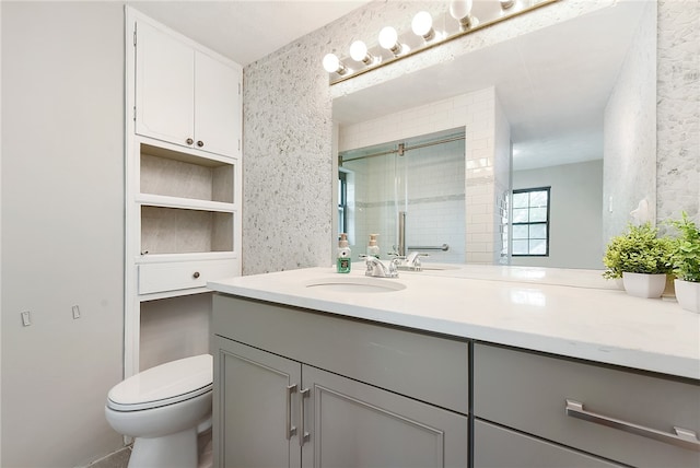 bathroom featuring vanity, walk in shower, and toilet