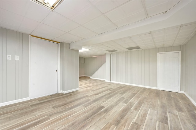 basement with light hardwood / wood-style floors