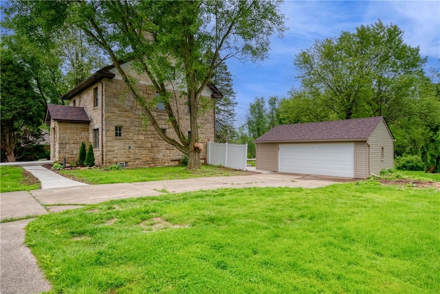 exterior space with an outdoor structure, a front lawn, and a garage