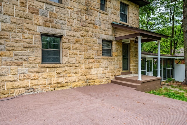 view of exterior entry featuring a patio area