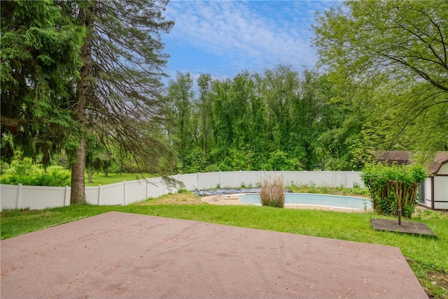 view of yard with a patio and a fenced in pool