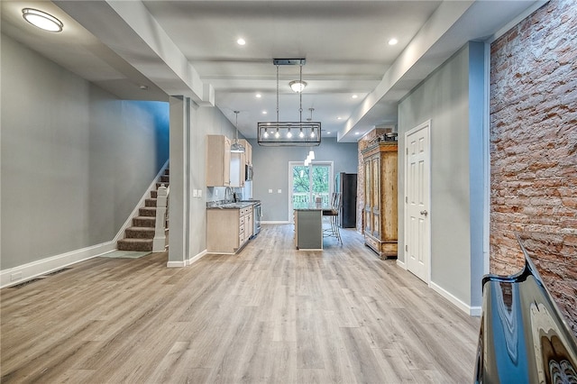 hallway featuring sink and light hardwood / wood-style floors