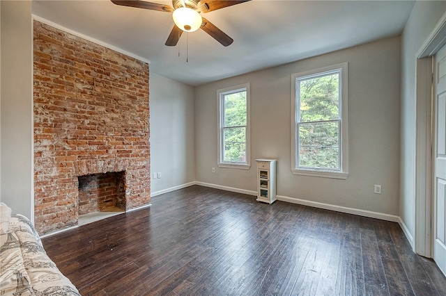 unfurnished living room featuring dark wood-type flooring, ceiling fan, and a fireplace