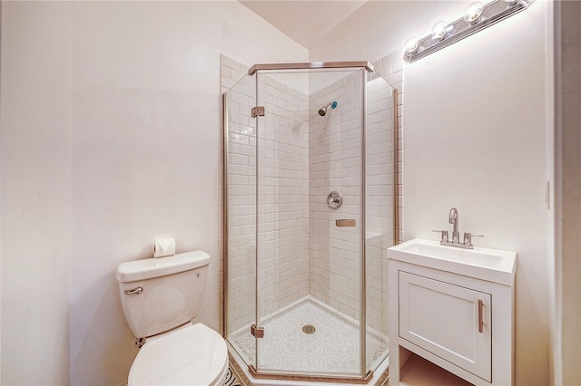 bathroom featuring vanity, toilet, and a shower with door