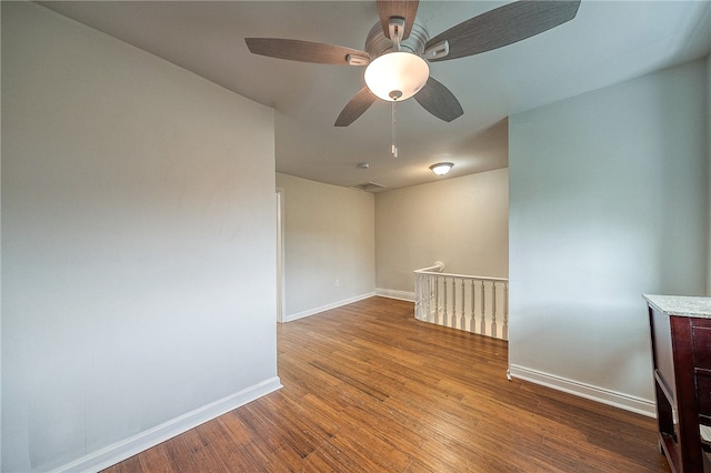 empty room with ceiling fan and wood-type flooring