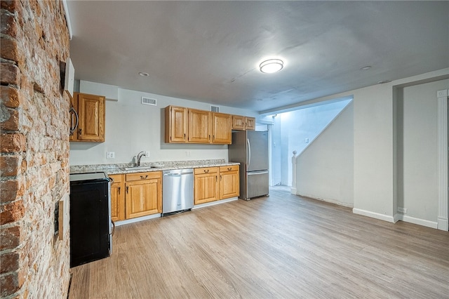 kitchen featuring stainless steel appliances, light hardwood / wood-style flooring, and sink