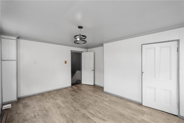 interior space with light hardwood / wood-style flooring and crown molding