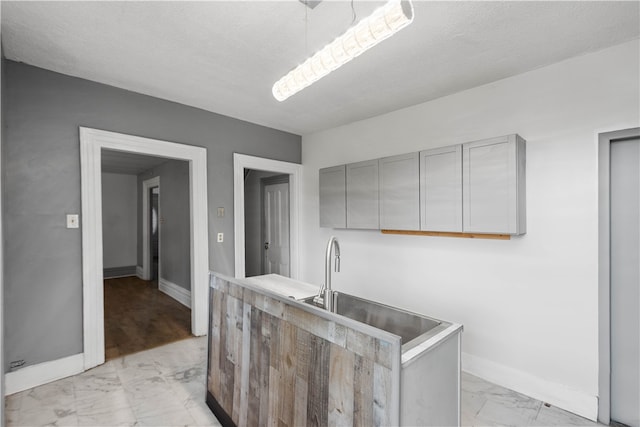 kitchen with gray cabinets and light tile floors