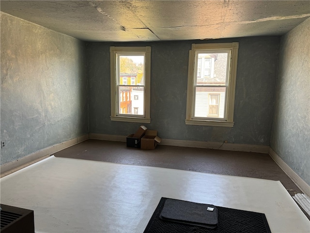 unfurnished room featuring concrete floors