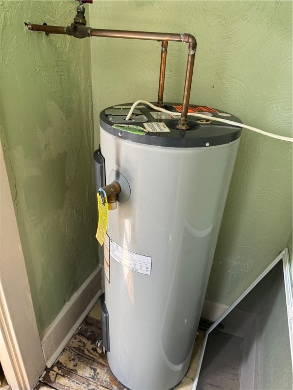 utility room featuring electric water heater