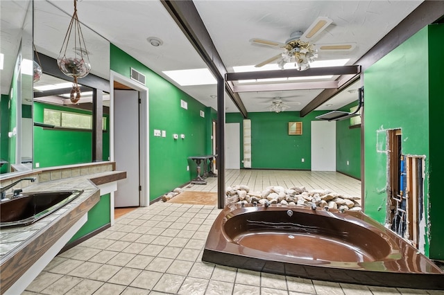 bathroom featuring tile flooring, sink, ceiling fan, and a relaxing tiled bath