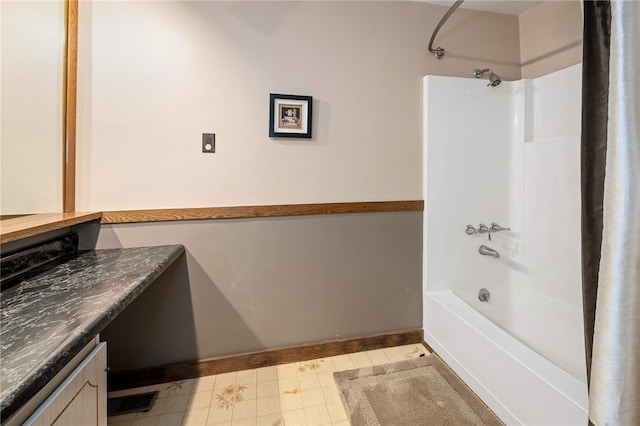 bathroom featuring vanity, shower / tub combo, and tile flooring