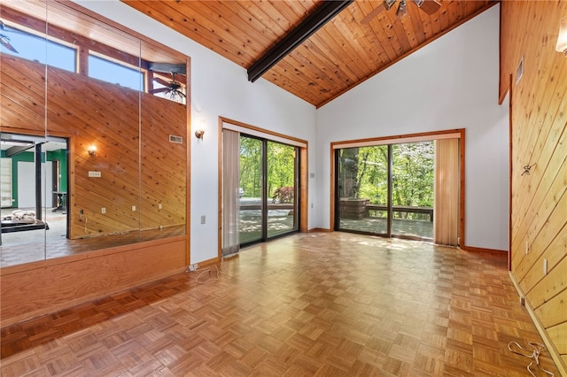 spare room featuring wood ceiling, wood walls, high vaulted ceiling, and parquet floors