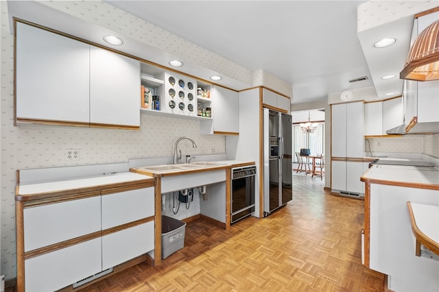 kitchen featuring white cabinets, wine cooler, stainless steel fridge with ice dispenser, and light parquet floors