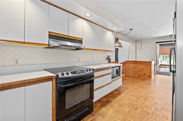 kitchen featuring white cabinets, light parquet floors, stainless steel appliances, and decorative light fixtures