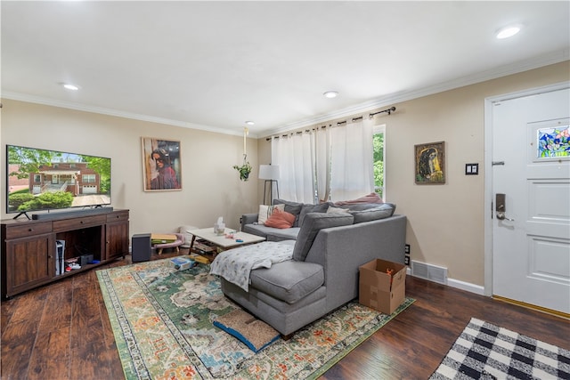 living room featuring ornamental molding, a healthy amount of sunlight, and dark wood-type flooring