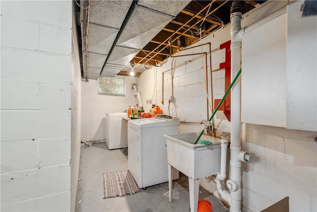 laundry area with washing machine and clothes dryer and sink