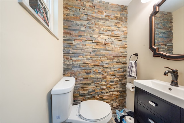 bathroom with toilet and large vanity