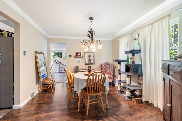 dining space featuring dark hardwood / wood-style floors, a notable chandelier, and crown molding