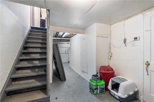 stairway with concrete flooring