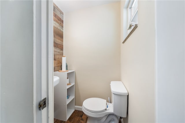 bathroom with hardwood / wood-style flooring and toilet