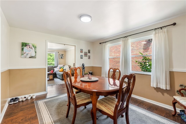 dining space with dark hardwood / wood-style flooring