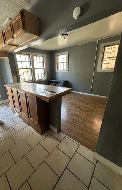 kitchen with tile counters and light tile floors