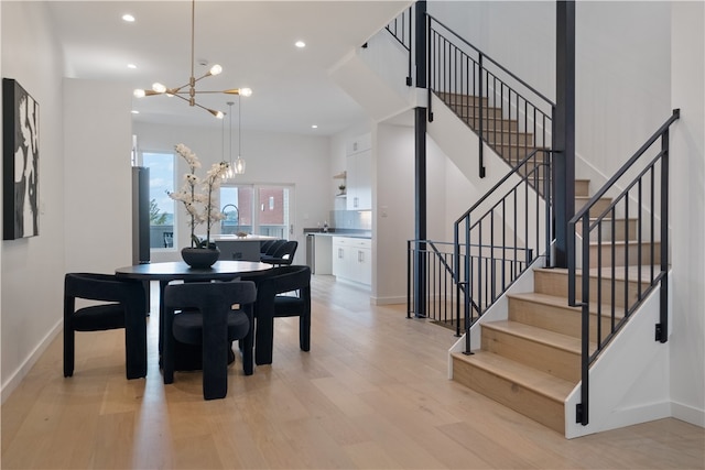 dining room featuring light hardwood / wood-style flooring and an inviting chandelier