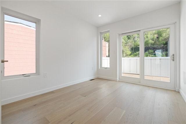 spare room featuring light hardwood / wood-style floors