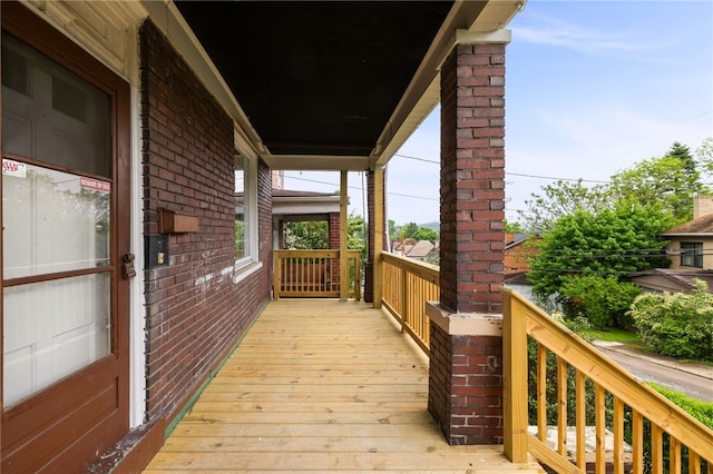 wooden terrace featuring a porch