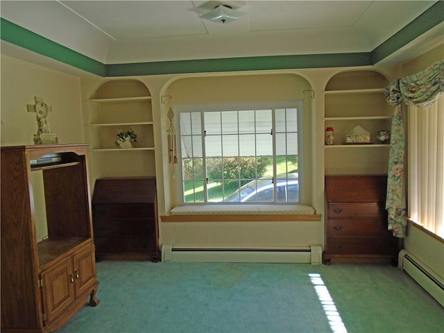 interior space with a wealth of natural light, carpet, and a baseboard radiator