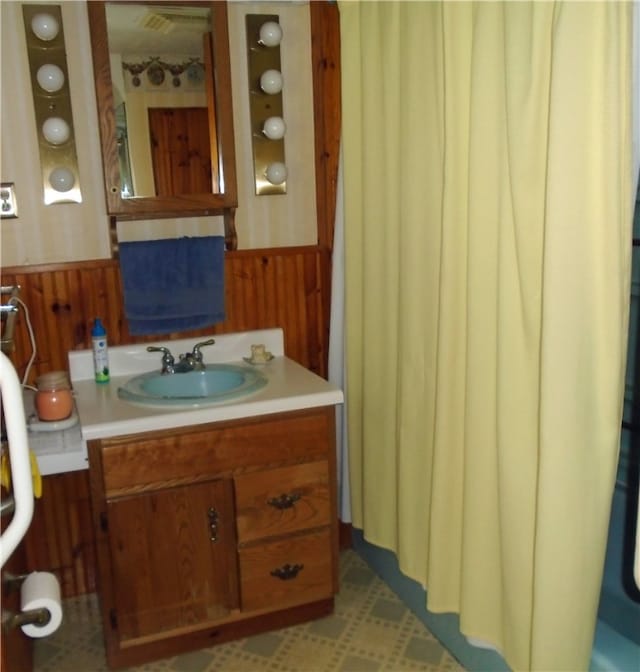 bathroom featuring tile floors and vanity with extensive cabinet space