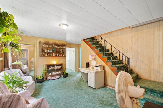 living room featuring wood walls and carpet floors