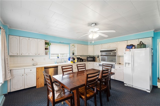 carpeted dining space with sink, ceiling fan, and a baseboard heating unit