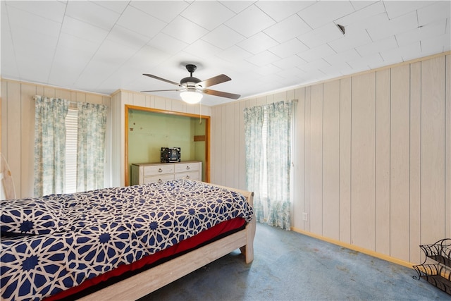 carpeted bedroom with multiple windows and ceiling fan