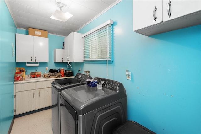 washroom with ornamental molding, independent washer and dryer, cabinets, and light tile floors