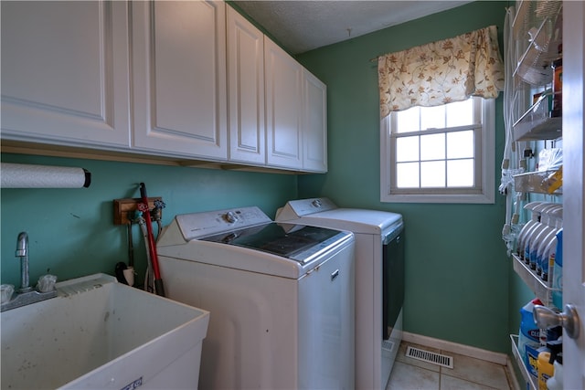 washroom featuring sink, cabinets, tile floors, and washer and clothes dryer