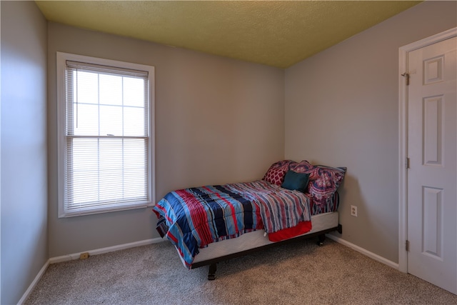 carpeted bedroom with a textured ceiling