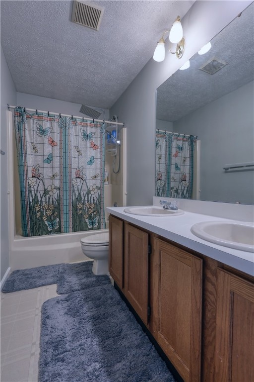 full bathroom featuring tile flooring, double sink vanity, a textured ceiling, shower / tub combo, and toilet