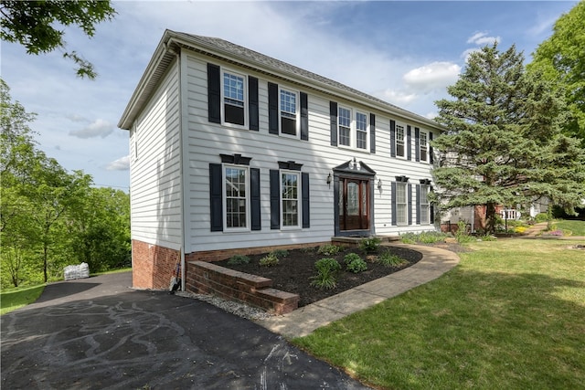 colonial-style house with a front yard