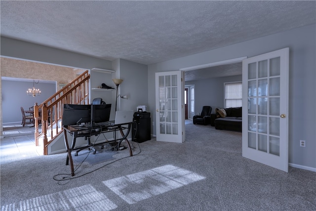 carpeted office with a wealth of natural light, a textured ceiling, french doors, and a notable chandelier