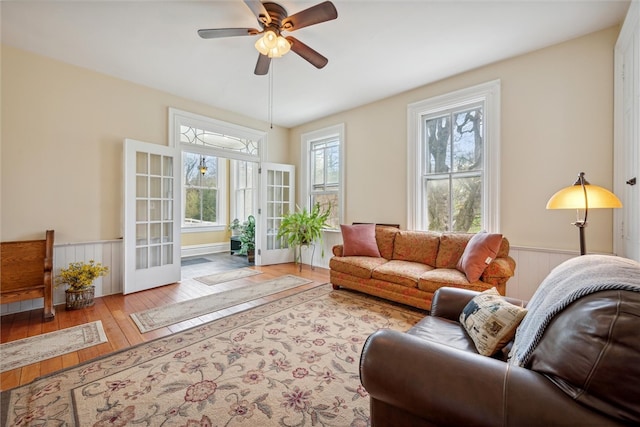 living room featuring hardwood / wood-style floors, ceiling fan, and french doors