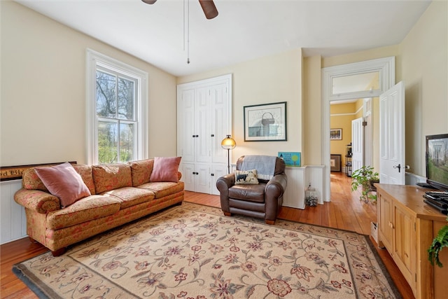 living room featuring ceiling fan and hardwood / wood-style floors